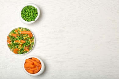 Flat lay composition with frozen vegetables on light background