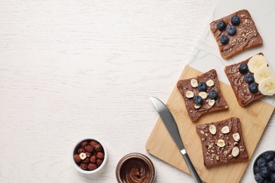 Photo of Different tasty toasts with nut butter and products on white wooden table, flat lay. Space for text