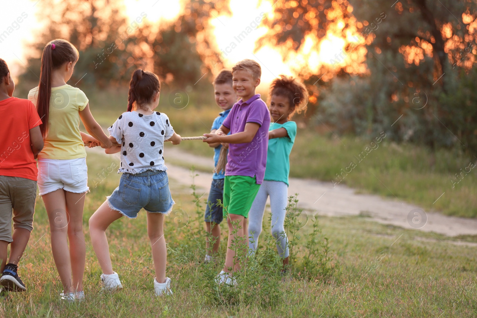 Photo of Cute little children playing outdoors at sunset