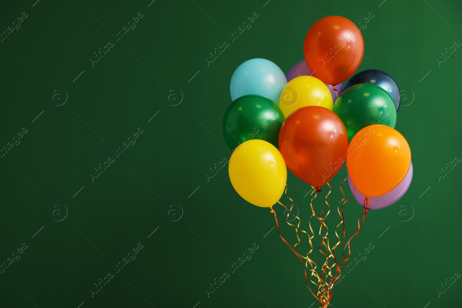 Photo of Bunch of bright balloons on color background, space for text. Celebration time