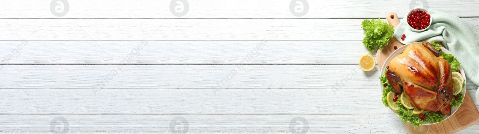 Image of Delicious roasted turkey served on white wooden table, top view with space for text. Banner design