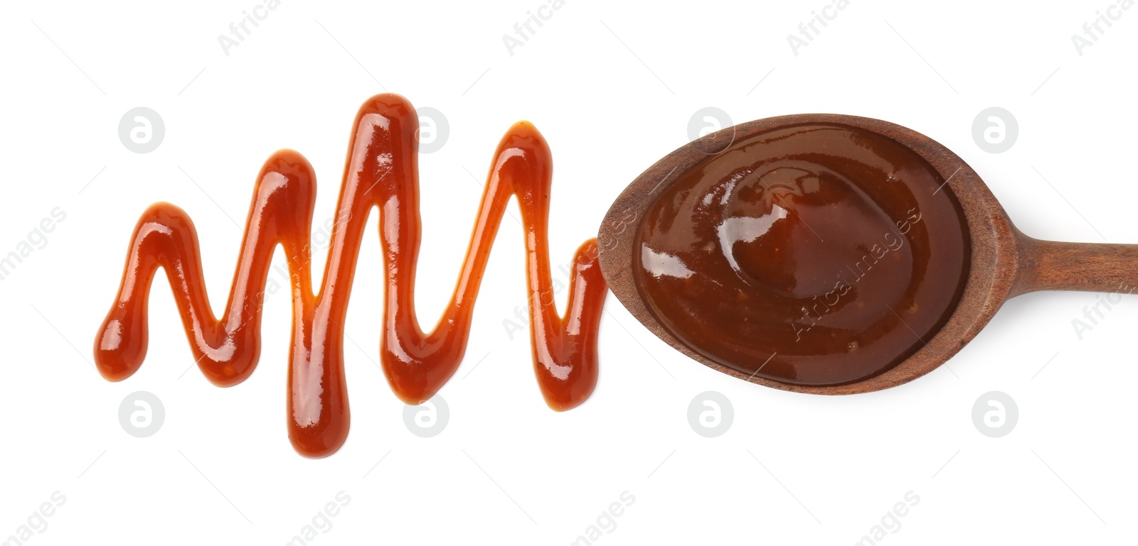 Photo of Tasty barbecue sauce and spoon isolated on white, top view