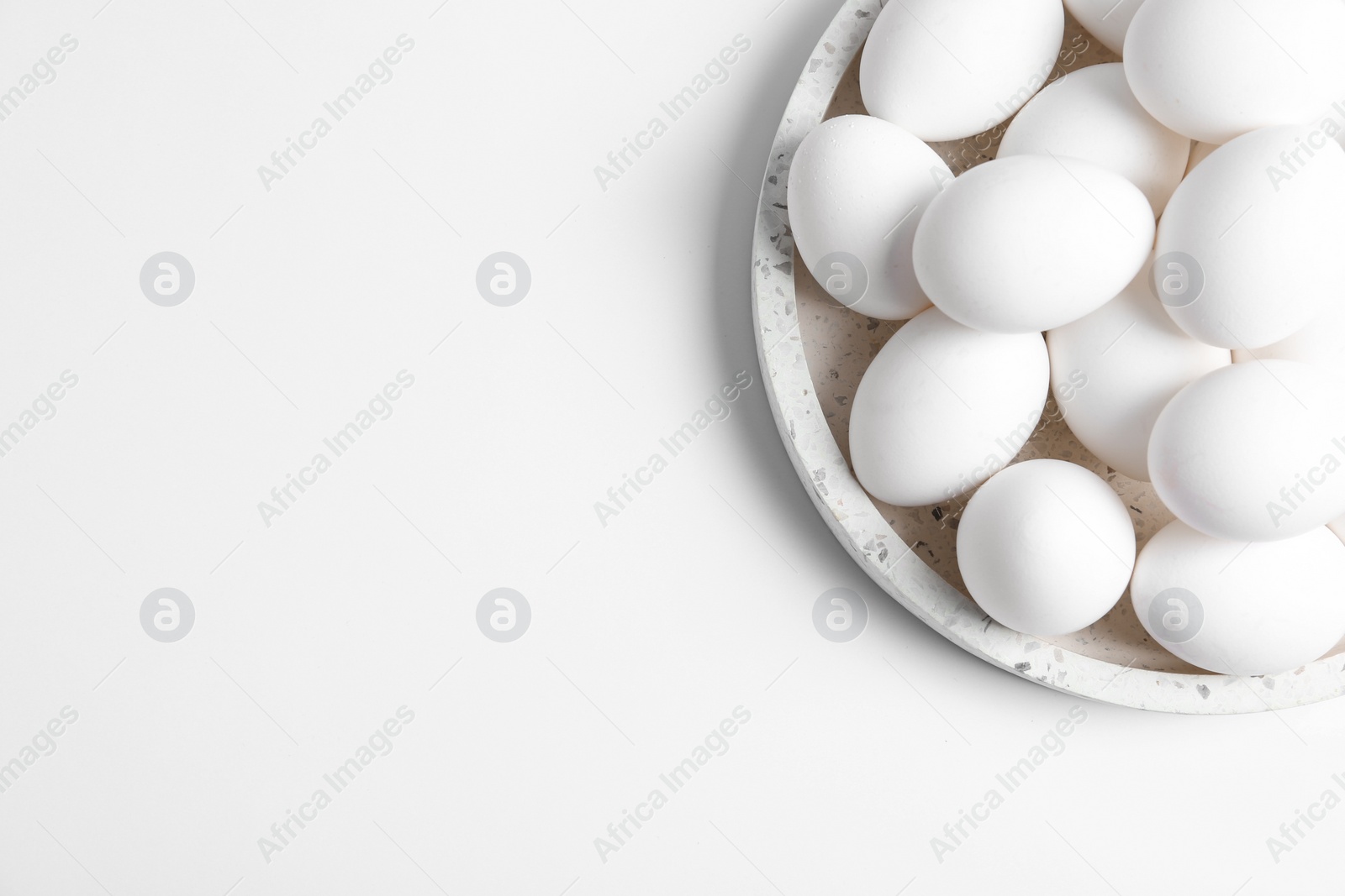 Photo of Fresh chicken eggs on white background, top view. Space for text