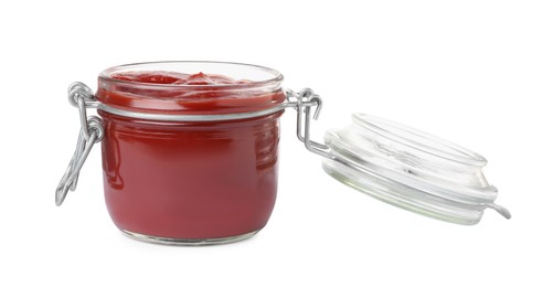 Photo of Tasty ketchup in glass jar isolated on white