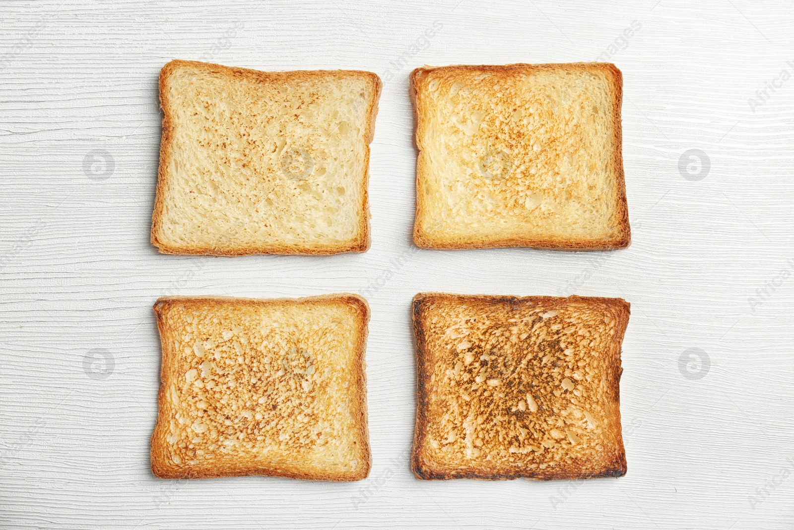 Photo of Toasted bread on light background, top view