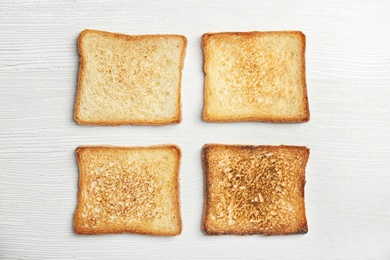 Photo of Toasted bread on light background, top view