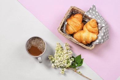 Photo of Flat lay composition with tasty croissants and cup of coffee on color background