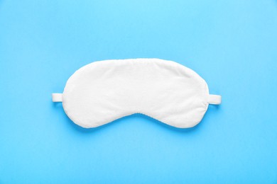 Soft sleep mask on light blue background, top view