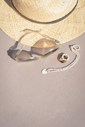 Stylish hat, sunglasses and jewelry on grey surface, flat lay. Space for text