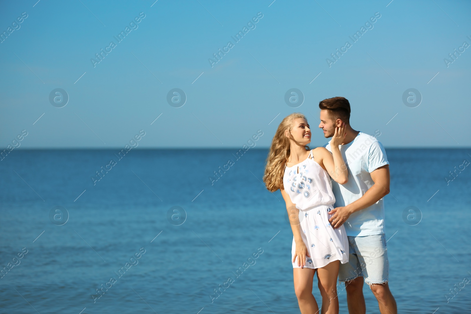 Photo of Happy young couple at beach on sunny day