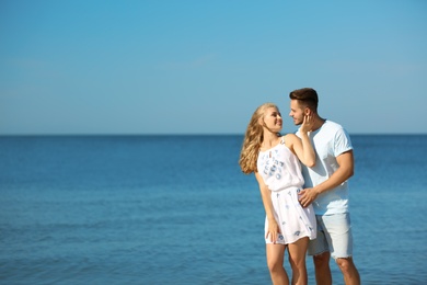 Photo of Happy young couple at beach on sunny day