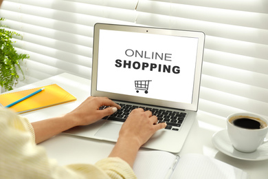 Woman using modern laptop for online shopping during quarantine, closeup. Delivery service