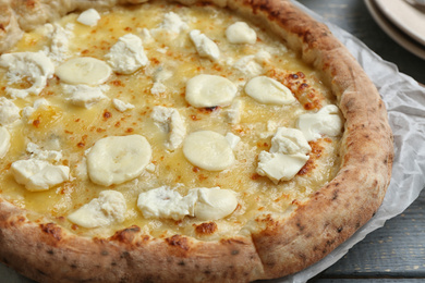 Photo of Delicious hot cheese pizza on grey wooden table, closeup