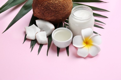 Photo of Beautiful composition with coconut oil and nuts on color background