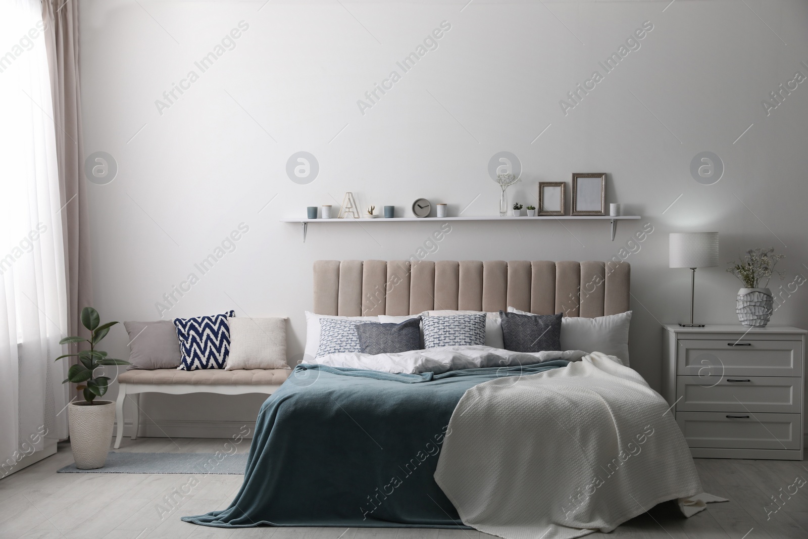 Photo of Comfortable bed with pillows in room. Stylish interior design