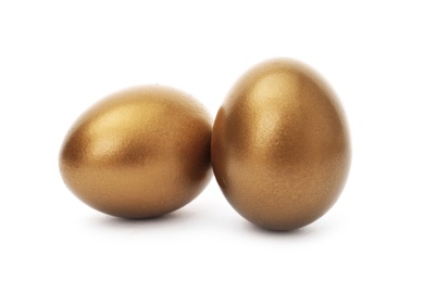 Two shiny golden eggs on white background