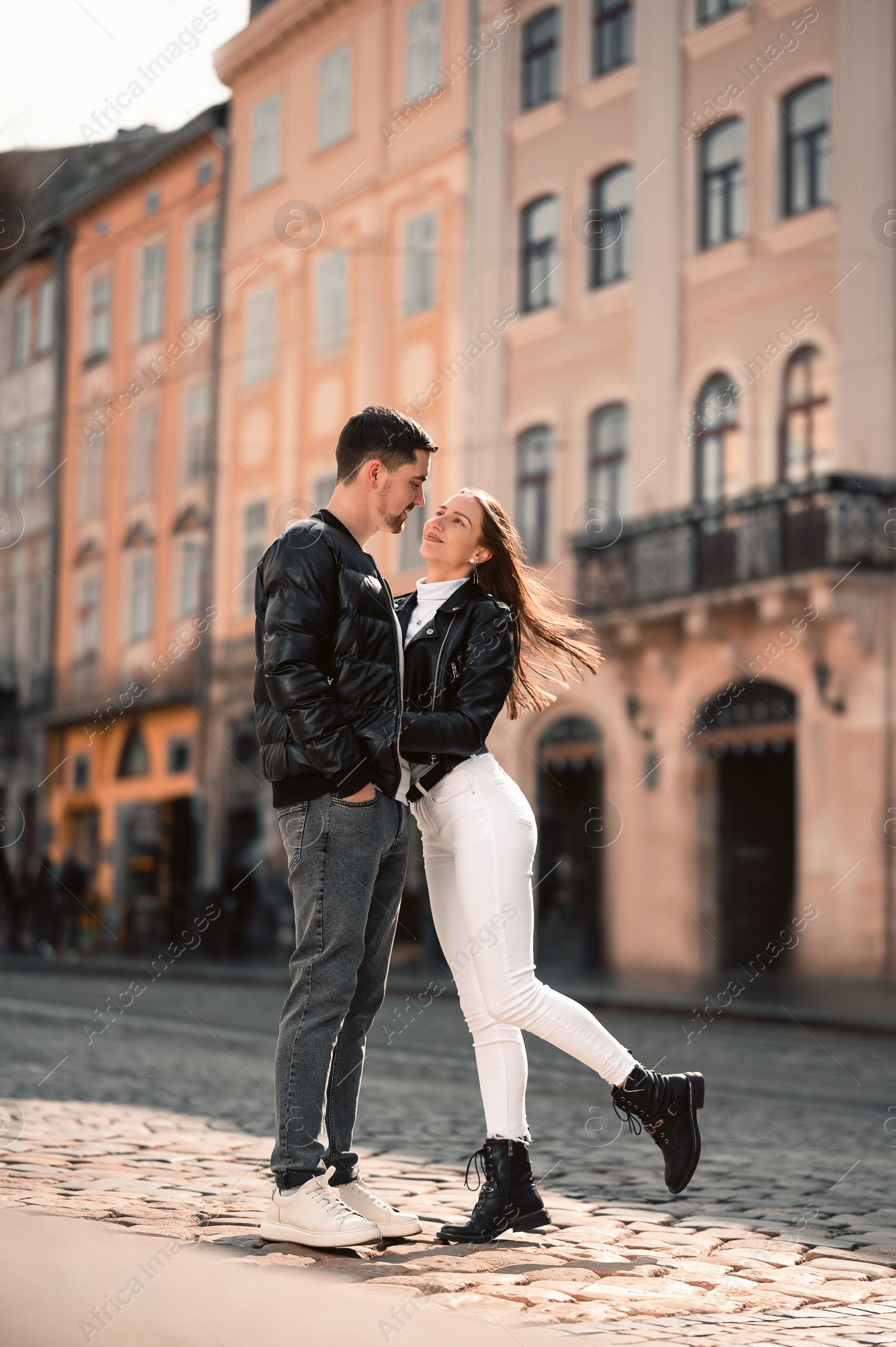 Photo of Lovely young couple together on city street. Romantic date