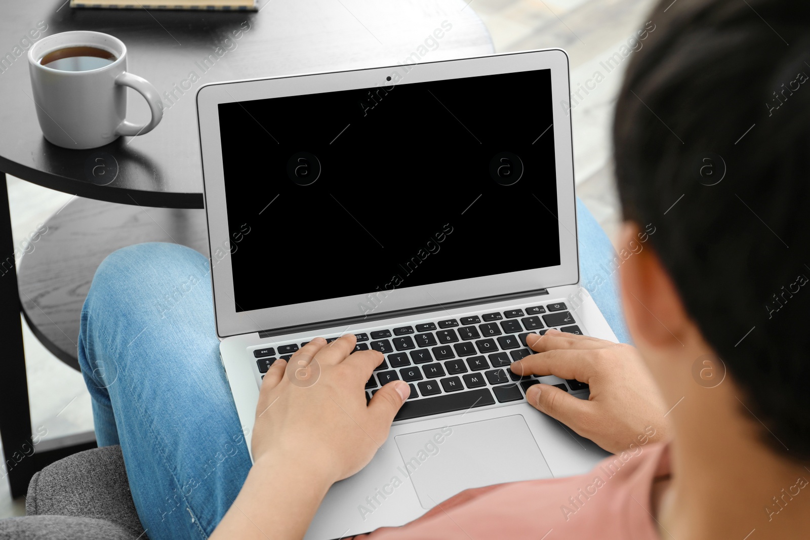 Photo of Man in casual clothes with laptop indoors