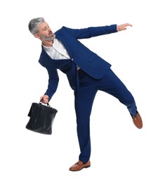Photo of Mature businessman with briefcase posing on white background