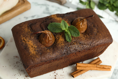 Photo of Tasty pear bread with mint and cinnamon on table. Homemade cake