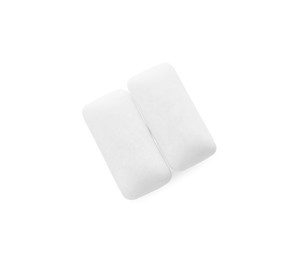 Photo of Two pieces of chewing gum on white background, top view