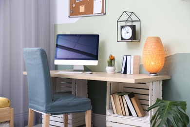 Comfortable workplace with computer on desk in home office