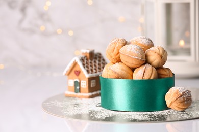 Photo of Box with delicious nut shaped cookies on white table, closeup. Space for text