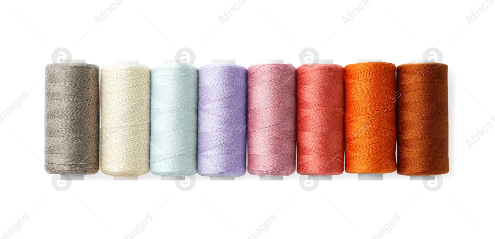 Photo of Set of different colorful sewing threads on white background, top view