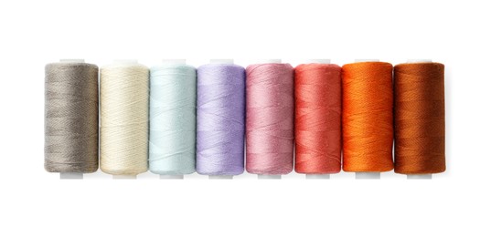 Photo of Set of different colorful sewing threads on white background, top view