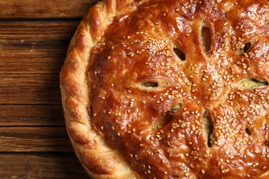 Photo of Tasty homemade pie with filling on wooden table, top view