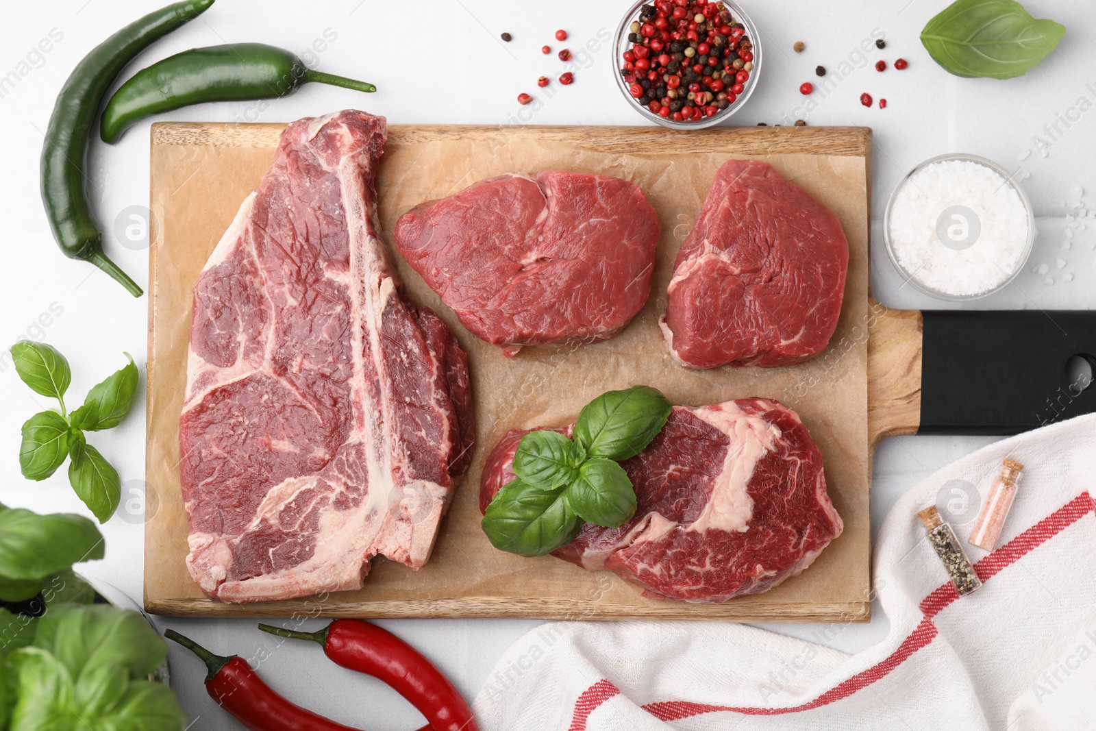 Photo of Flat lay composition with cut fresh beef meat and spices on white table