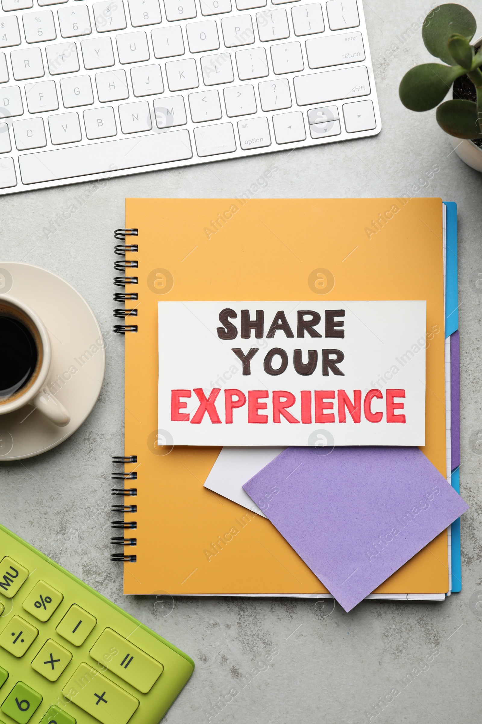 Photo of Share Your Experience. Flat lay composition with card, stationery and coffee on light table