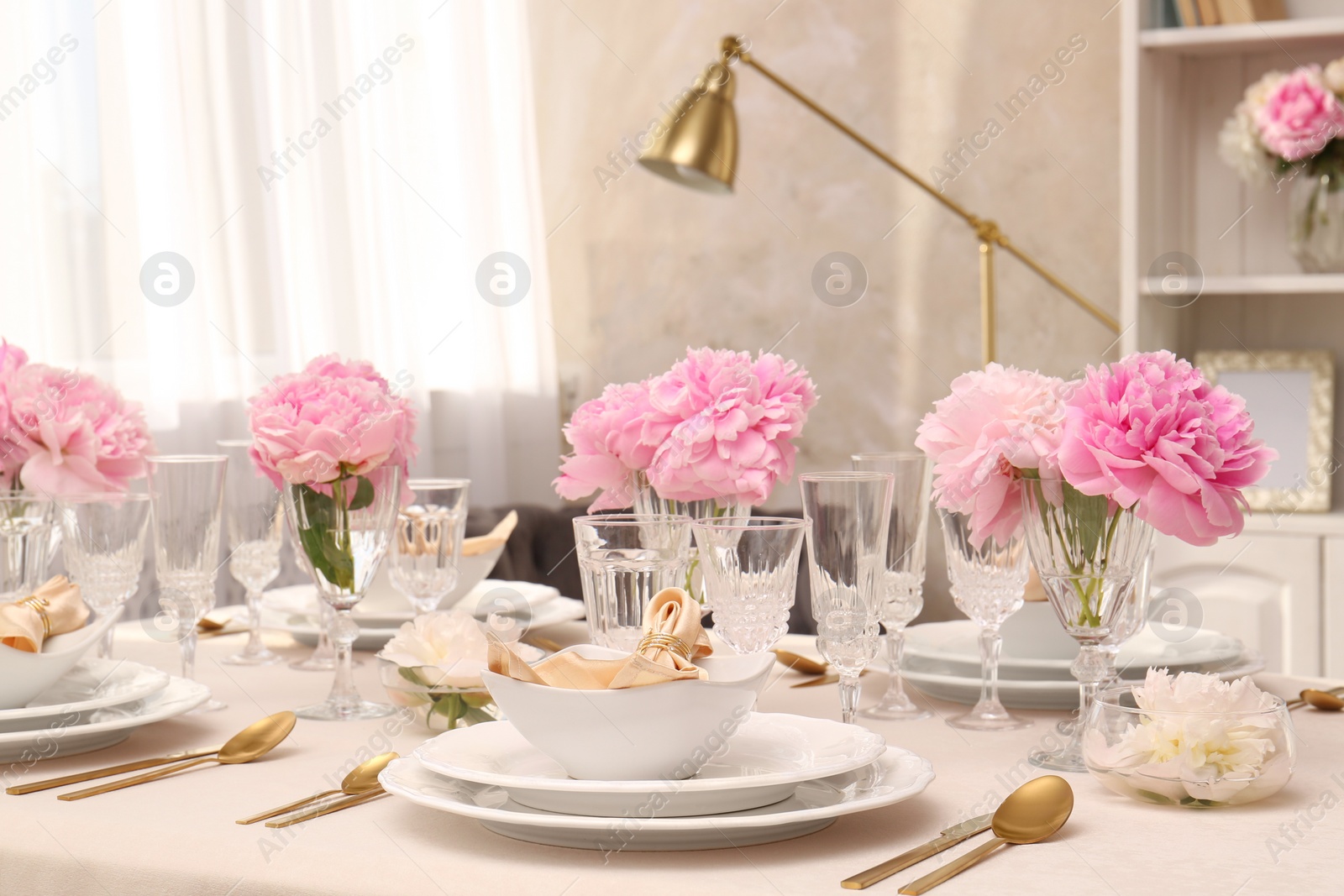 Photo of Stylish table setting with beautiful peonies and fabric napkins indoors