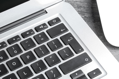 Photo of Closeup view of modern laptop keyboard on table