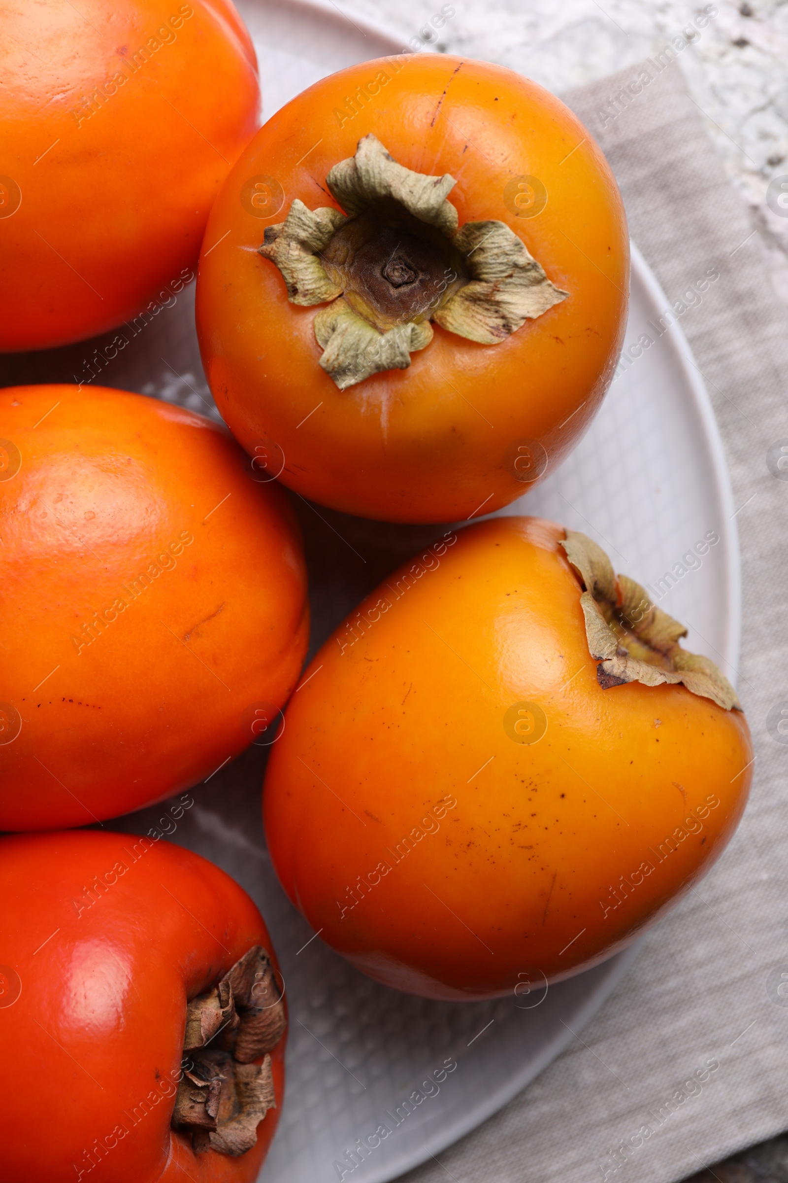 Photo of Delicious ripe persimmons on table, top view