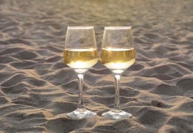 Photo of Glassestasty white wine on sand