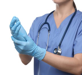 Doctor wearing light blue medical gloves on white background, closeup