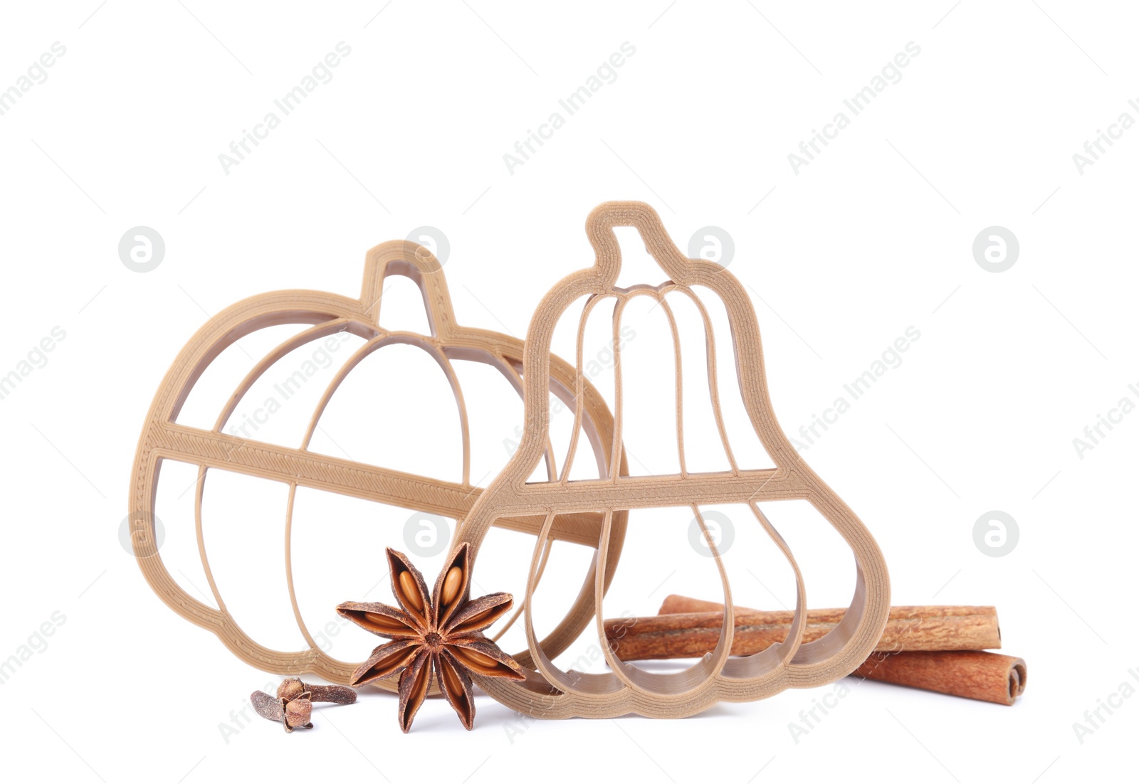 Photo of Cookie cutters in shape of pumpkin and spices on white background