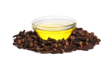 Essential oil and dried cloves on white background