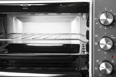 Photo of Open electric oven, closeup view. Cooking appliance