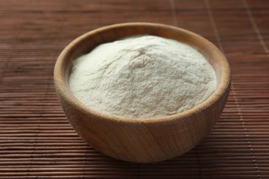 Photo of Bowl of agar-agar powder on bamboo mat, closeup