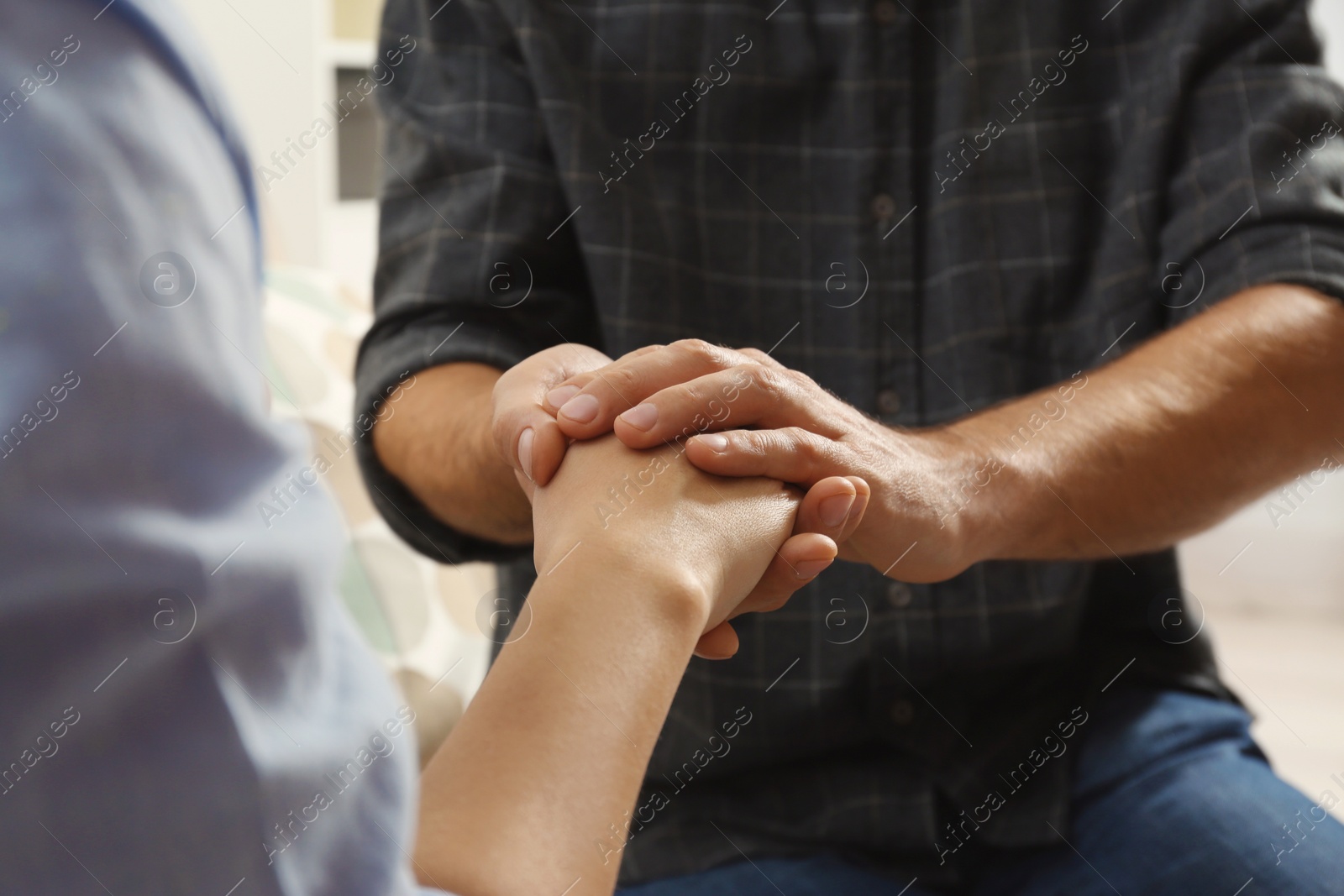 Photo of Man comforting woman, closeup of hands. Help and support concept