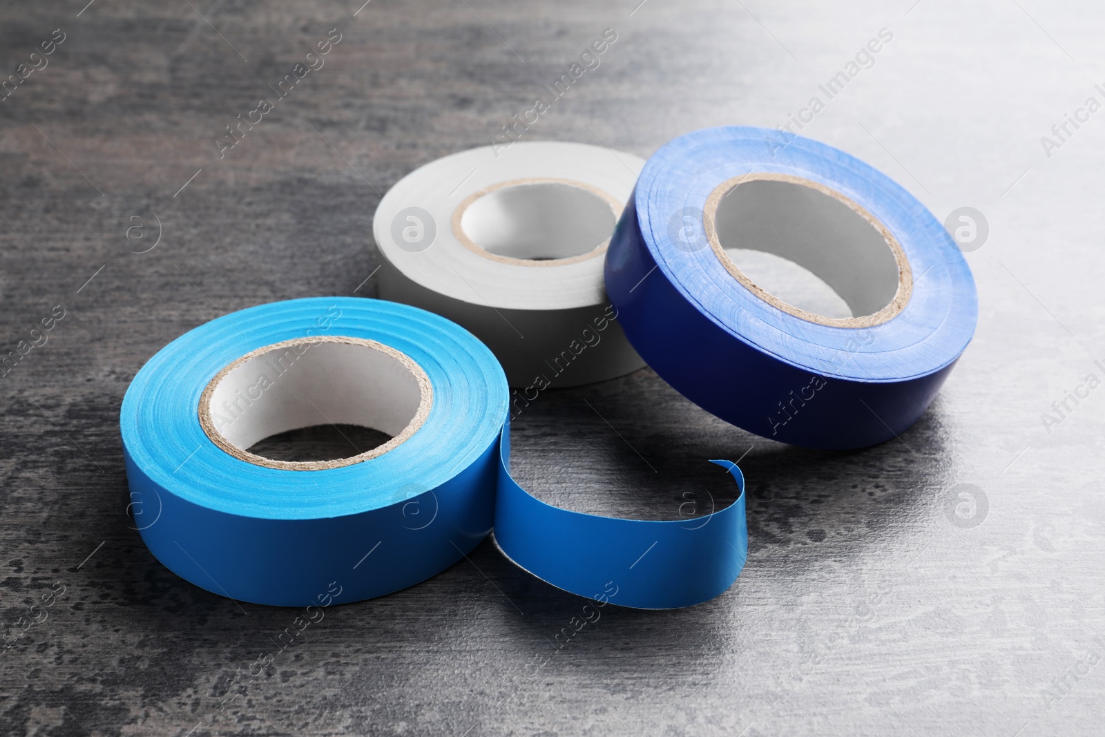 Photo of Colorful insulating tapes on dark gray background