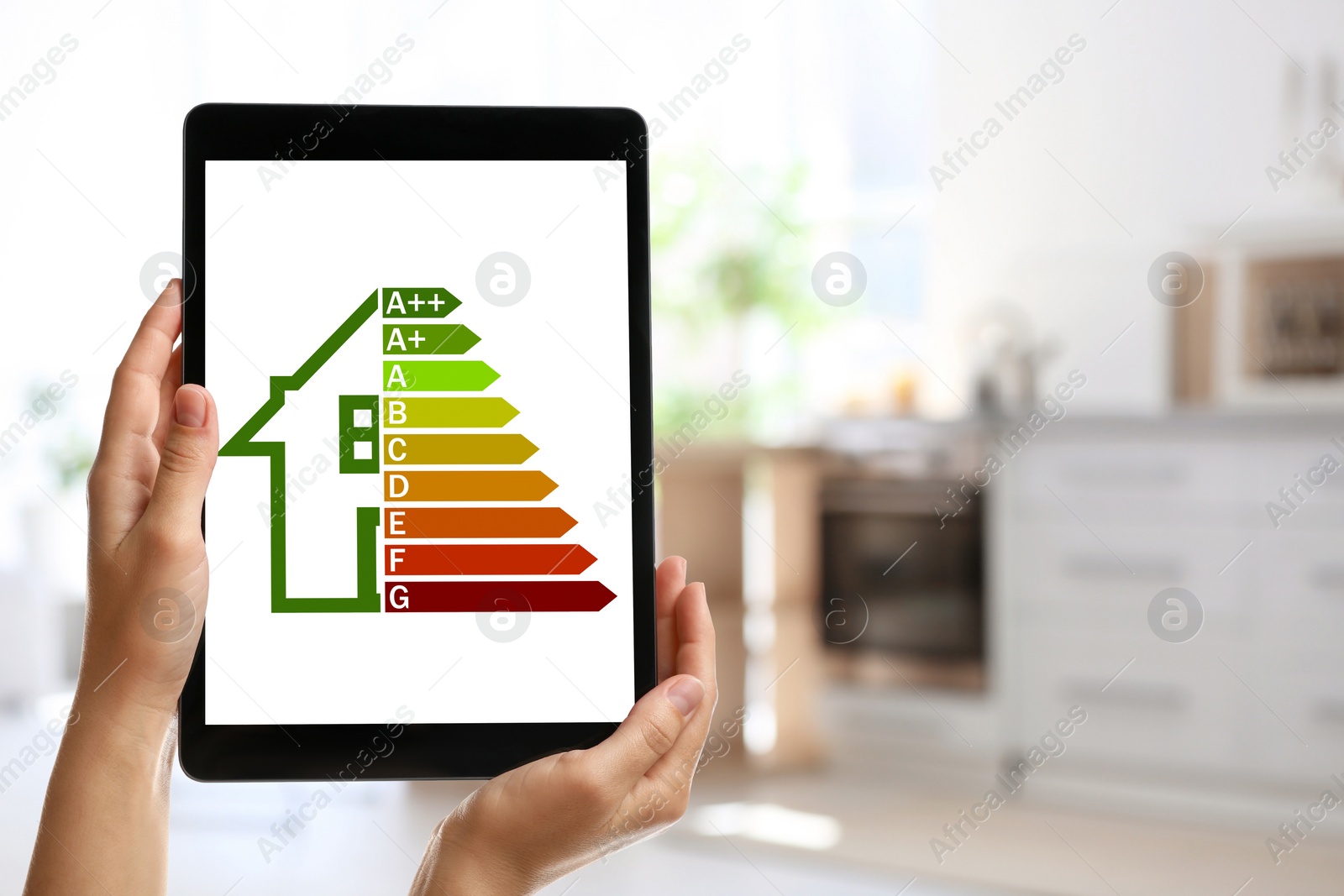 Image of Energy efficiency. Woman using tablet with colorful rating on display indoors, closeup