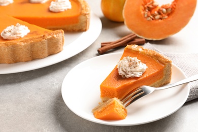 Photo of Plate with piece of fresh delicious homemade pumpkin pie on light table