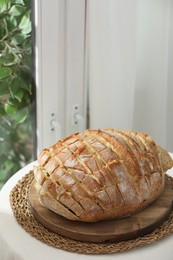 Photo of Freshly baked bread with tofu cheese on table indoors