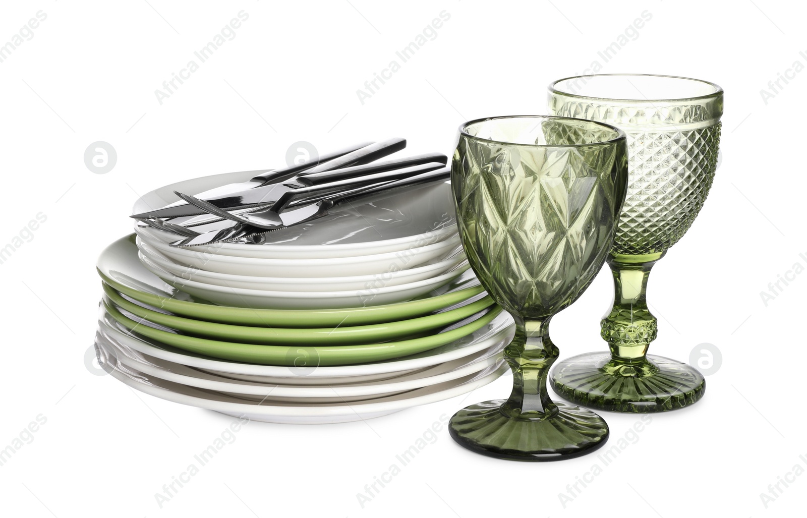 Photo of Set of beautiful ceramic plates, glasses and cutlery isolated on white