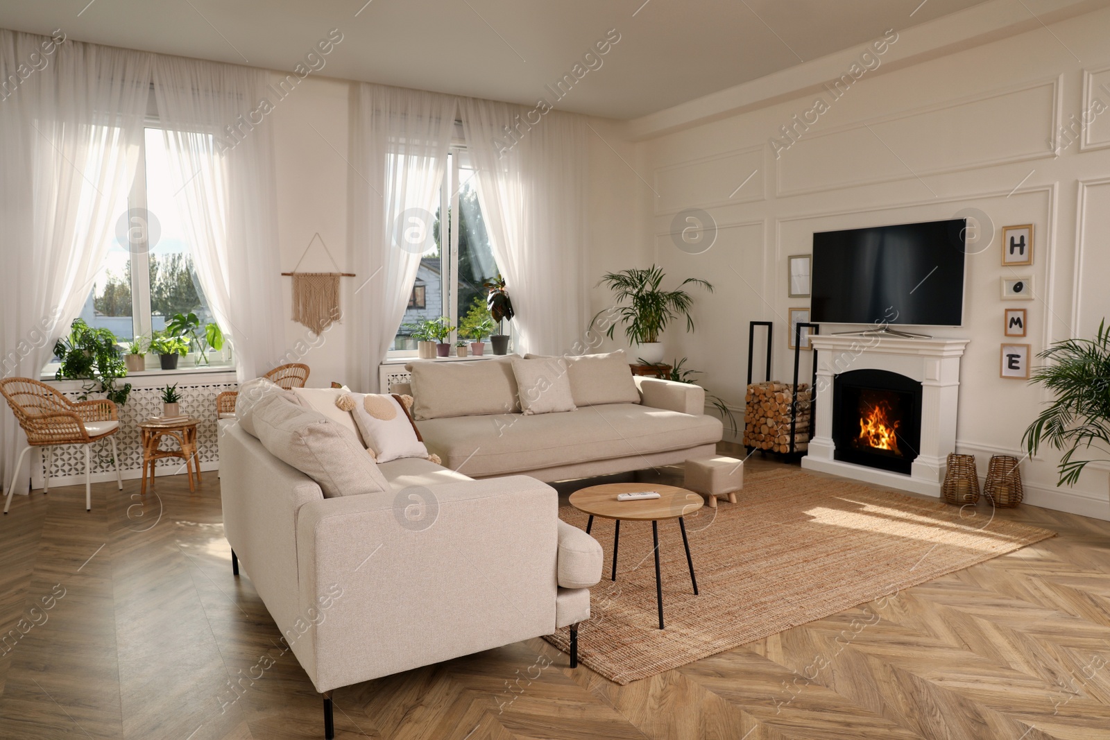 Photo of Stylish living room with comfortable sofas, modern TV and fireplace. Interior design