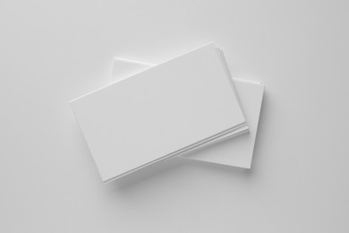 Photo of Blank business cards on white background, top view. Mockup for design