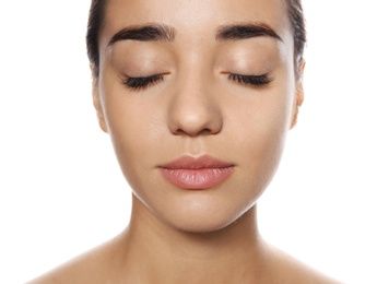 Photo of Portrait of young woman with foundation on her face against white background